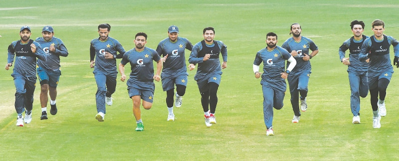 LAHORE: Pakistan cricketers sprint during a practice session at the Gaddafi Stadium on Thursday.—M. Arif/White Star