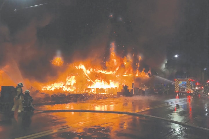 TAIPEI: Firefighters battling the deadly blaze that tore through the building in the southern Taiwanese city of Kaohsiung.—AFP