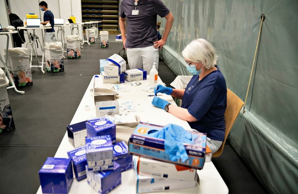 A medical worker handles syringes as Danes get vaccinated against the coronavirus at the vaccination site in Arena Nord in Frederikshavn, Jutland, Denmark on April 12. — Reuters