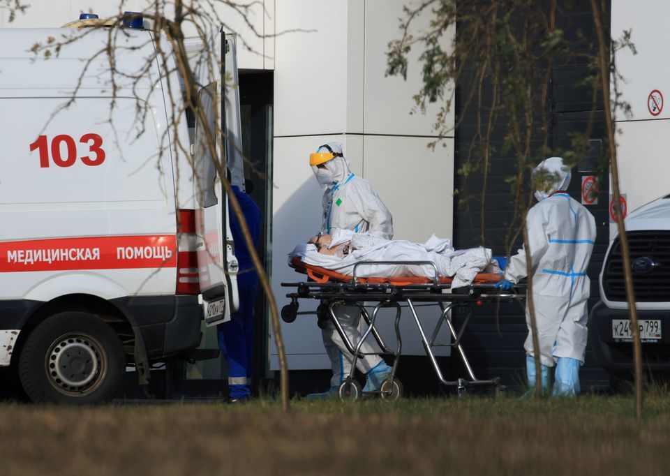 Medical specialists transport a patient outside a hospital for people infected with the coronavirus in Moscow, Russia, October 13. — Reuters