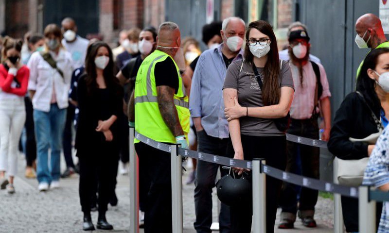 In this file photo, people queue to receive a vaccine against Covid-19 during a night of vaccinations with music at the Arena Treptow vaccination centre in Berlin, Germany. — Reuters/File