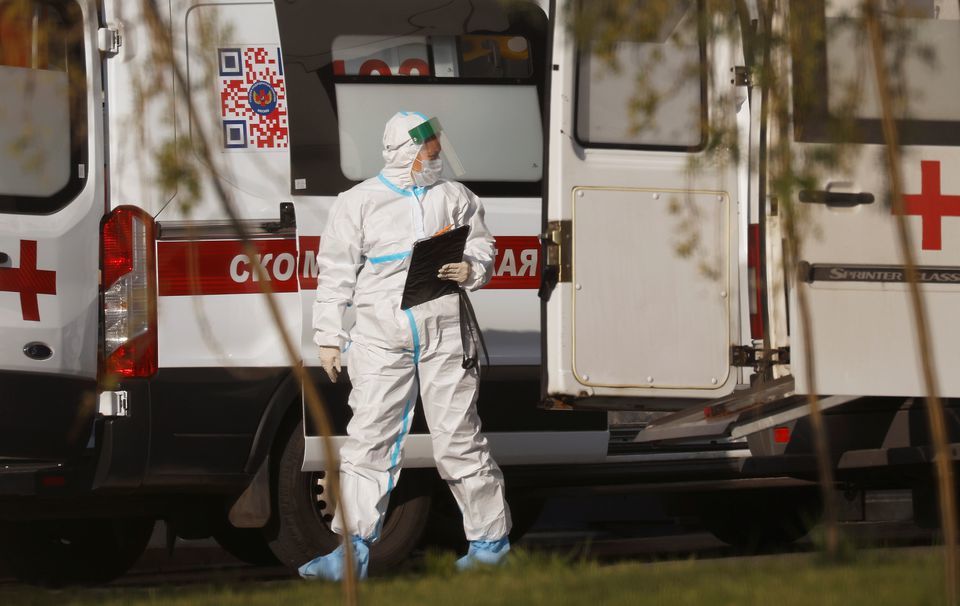 A medical specialist walks by an ambulance outside a hospital for patients infected with the coronavirus in Moscow, Russia, October 6. &mdash; Reuters
