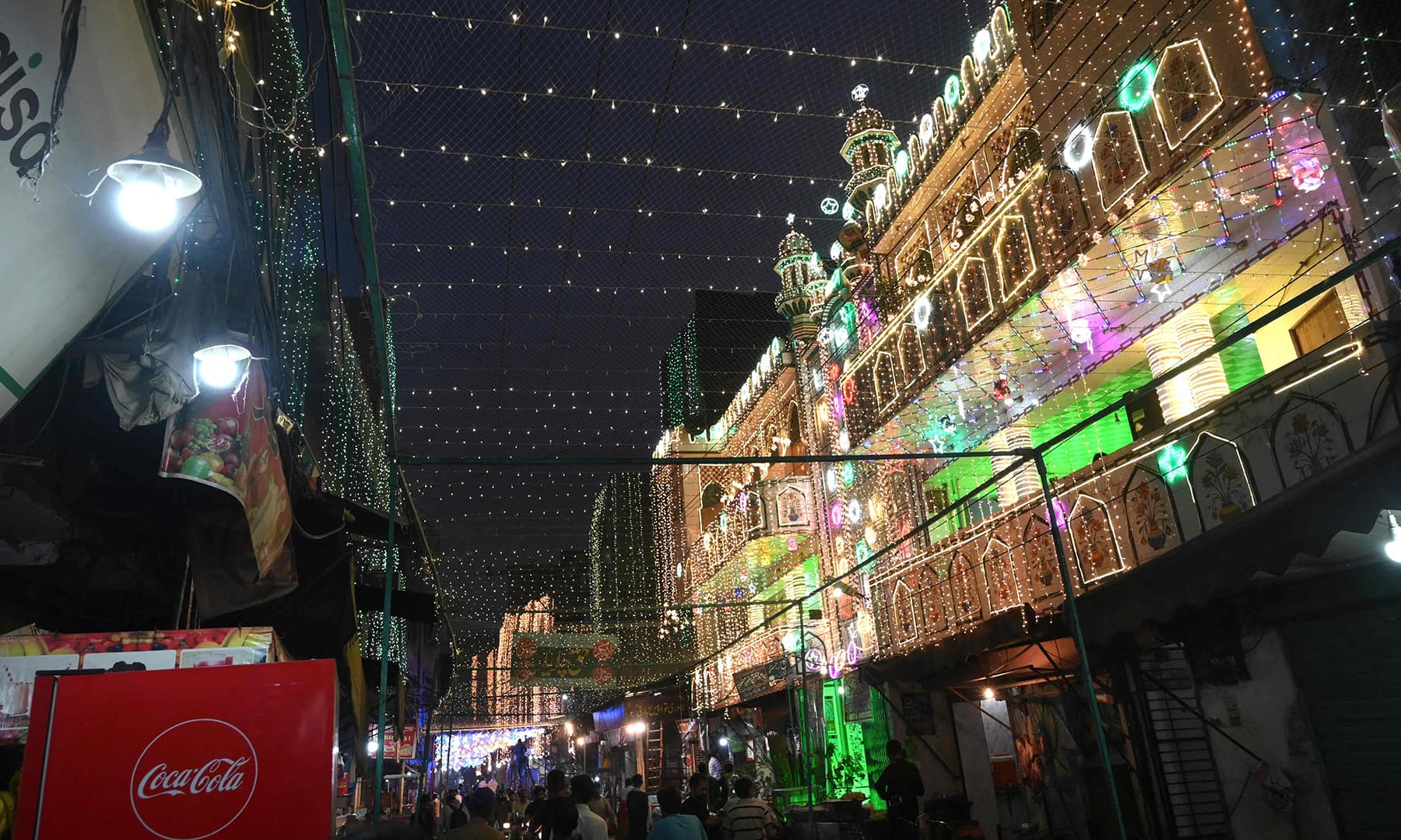 People walk past a decorated mosque during the celebrations for Eid Miladun Nabi in Lahore on October 18. — AFP