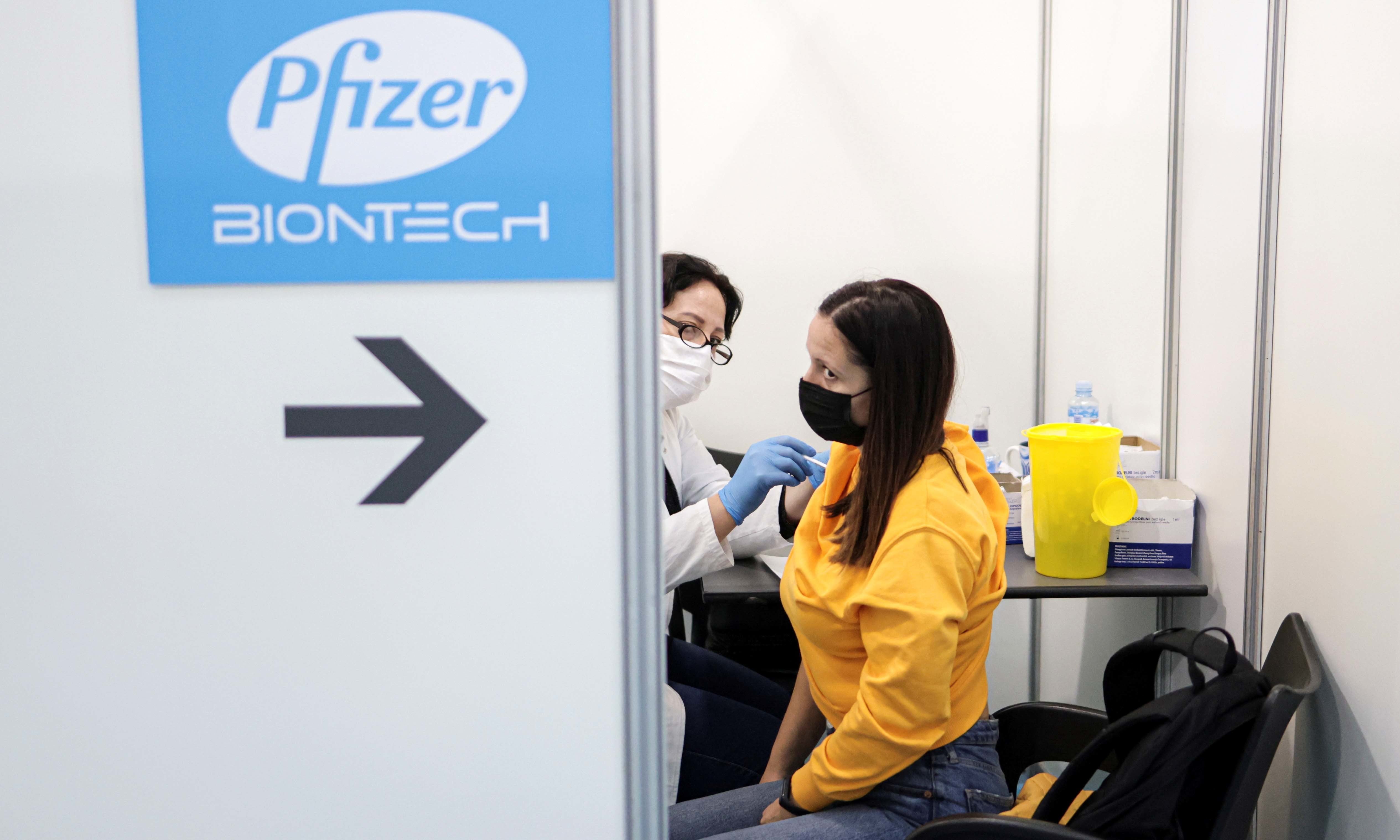 A healthcare worker administers a dose of Pfizer's coronavirus vaccine to a woman at Belgrade Fair vaccination centre in Belgrade, Serbia on October 15. — Reuters