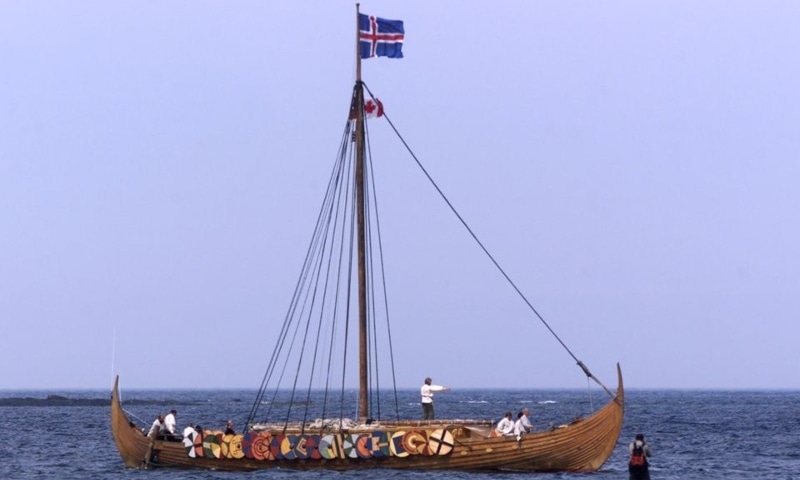 A tourist (R) photographs the Viking replica ship the Islendingur as it arrives in the fishing village of L'Anse aux Meadows in Newfoundland, Canada, July 28, 2000. &mdash; Reuters/File