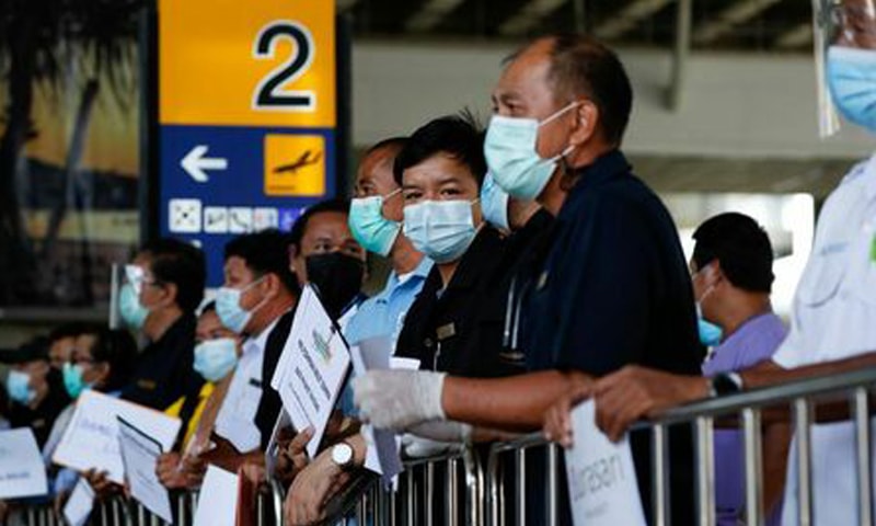 In this file photo, hotel drivers wait for passengers at the airport in Phuket, Thailand. &mdash; Reuters/File