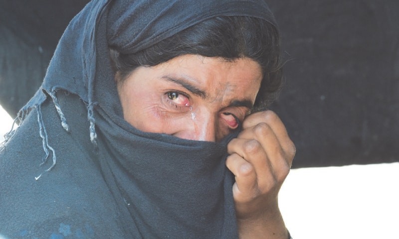 ZAITOON pictured in her tent, shedding tears. She was deported to Afghanistan along with her family.