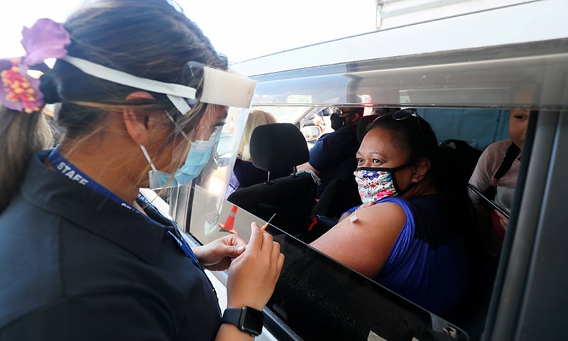 A member of the public receives a Pfizer vaccine at a drive-through coronavirus vaccination clinic in Otara, New Zealand. — Reuters/File