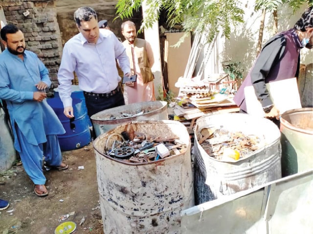 Deputy Commissioner Dr Imran Hamid Sheikh visits a junkyard in Attock on Monday. — Dawn