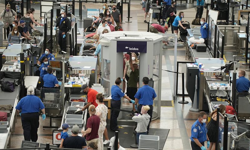 Travellers wear face coverings in the line for the south security checkpoint in the main terminal of Denver International Airport in Denver, US. — AP/File