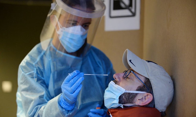 In this file photo, a healthcare worker takes a nasal swab sample from a man for a Covid-19 test at a testing site in Brussels. — Reuters/File