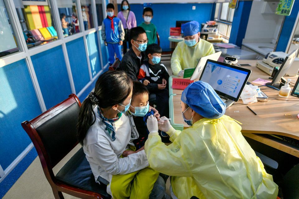 A medical worker administers a dose of a coronavirus vaccine to a child in Huzhou, Zhejiang province, China, October 26. — Reuters