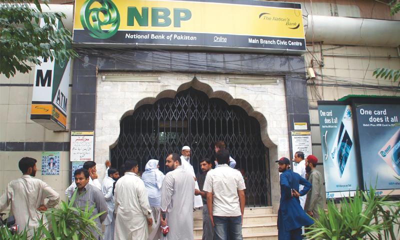 This image shows citizens lined up outside a National Bank of Pakistan branch in Karachi. — APP/File