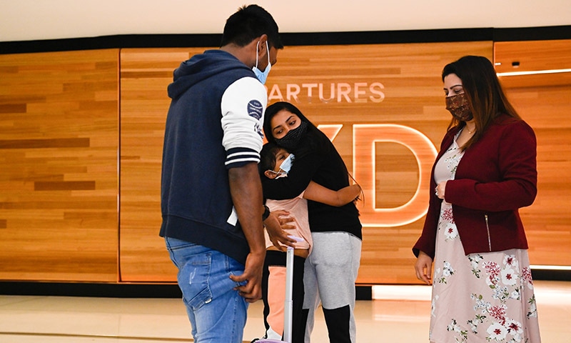Departing travellers hug at Sydney Airport in the wake of coronavirus border restrictions easing, with fully vaccinated Australians being allowed to leave Sydney without requiring a travel exemption for the first time since March 2020, in Sydney, Australia. — Reuters