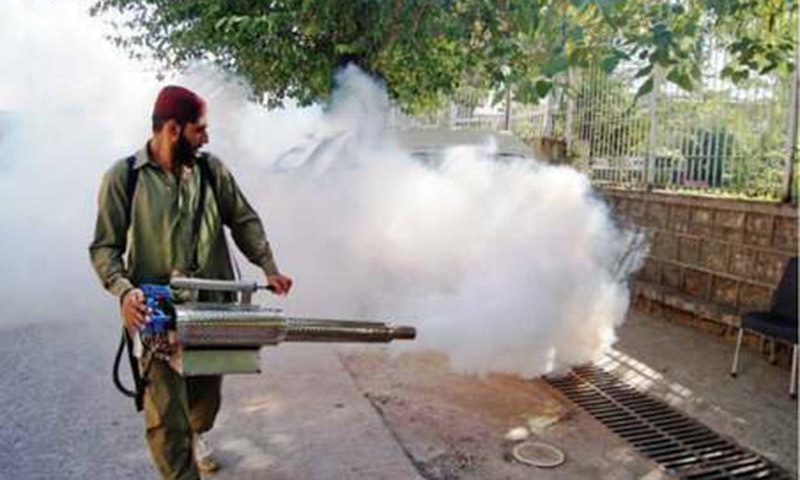 A worker carries out anti-dengue fumigation at Chandni Chowk in Rawalpindi on Sunday. — Online A worker carries out anti-dengue fumigation at Chandni Chowk in Rawalpindi on Sunday. — Online