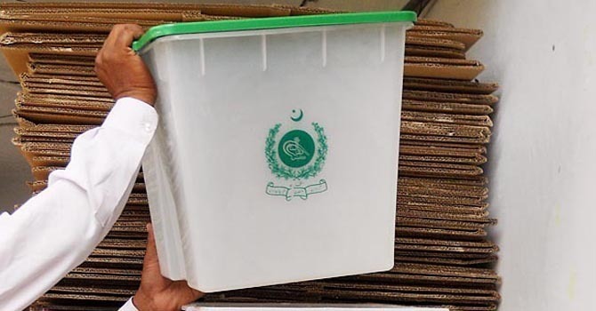 A worker sorting ballot boxes at the office of Election Commission of Pakistan. — Online/File