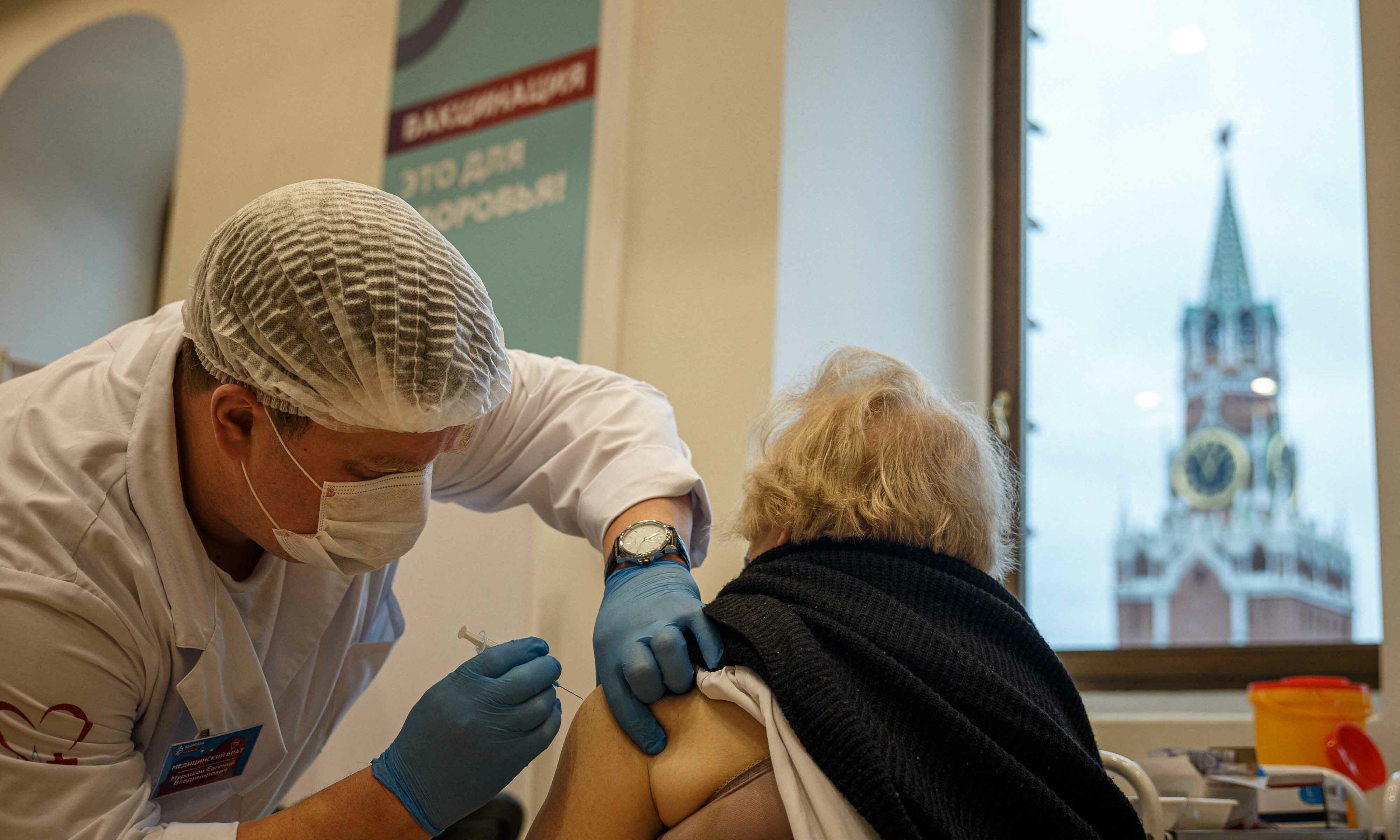 A healthcare worker administers a dose of Russia's Sputnik V Covid vaccine to a patient at a vaccination centre in the GUM State Department store in Moscow on October 21. — AFP