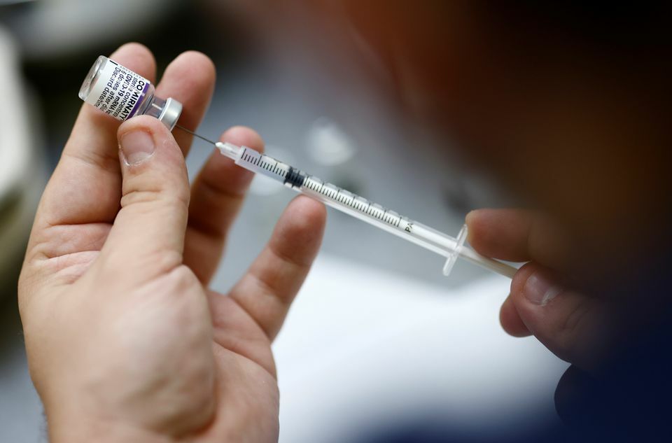 A medical worker prepares a dose of the "Comirnaty" Pfizer BioNTech Covid-19 vaccine in a vaccination centre in Nantes, France, October 6. — Reuters