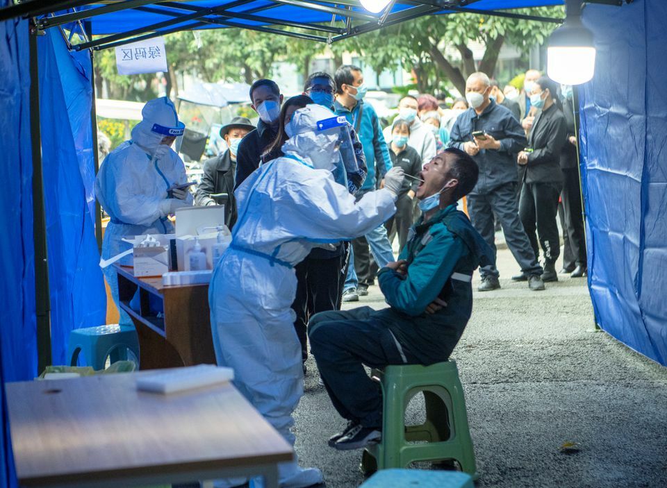 People line up at a makeshift nucleic acid testing site near a residential compound under lockdown following local cases of the coronavirus in Chengdu, Sichuan province, China, November 3. — Reuters