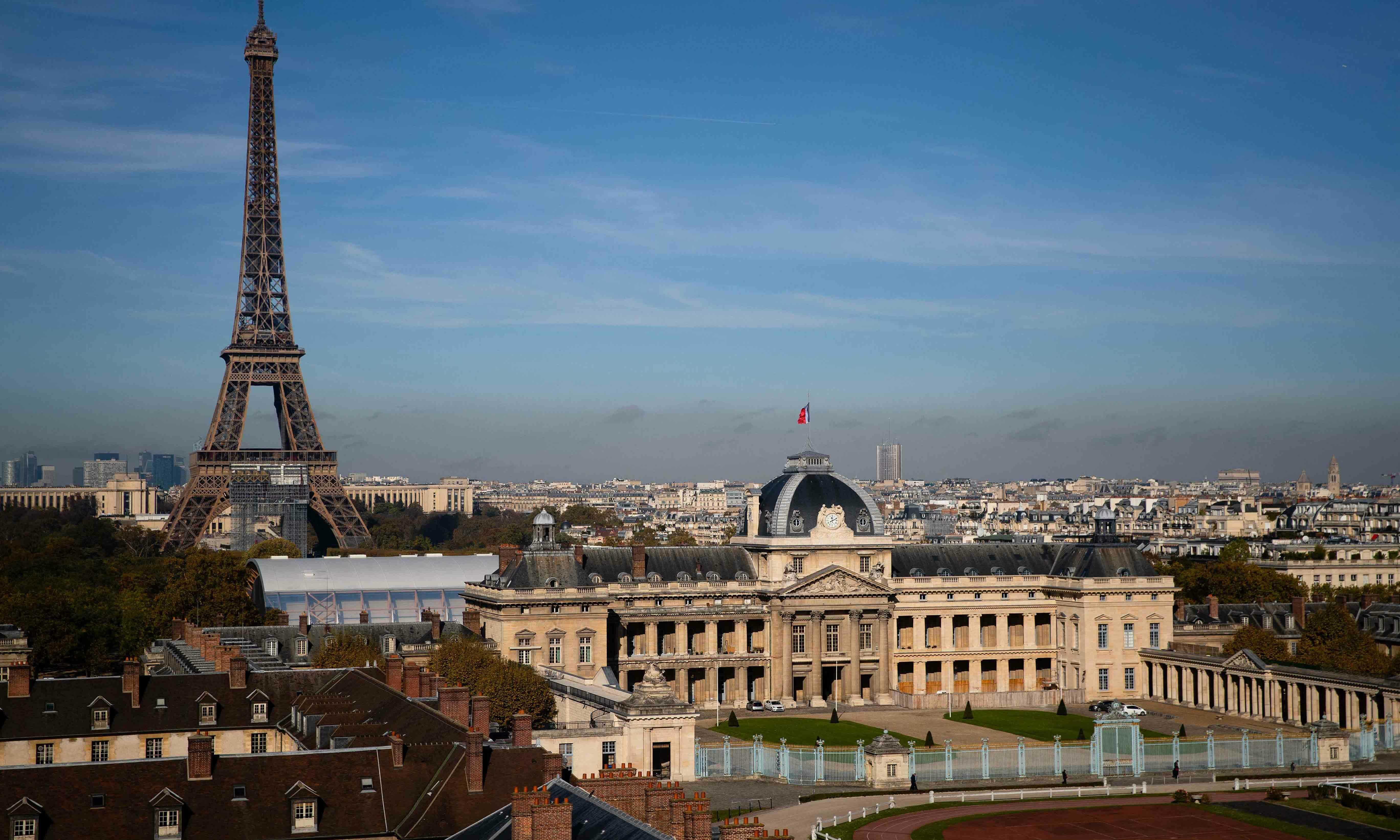This file photograph taken on October 27 shows a general view of The Ecole Militaire (military school) and The Eiffel Tower (L) in Paris. — AFP