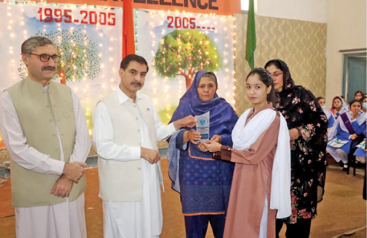 A position holder being awarded a shield at a ceremony at the University Model School, Peshawar, on Thursday. &mdash; Dawn