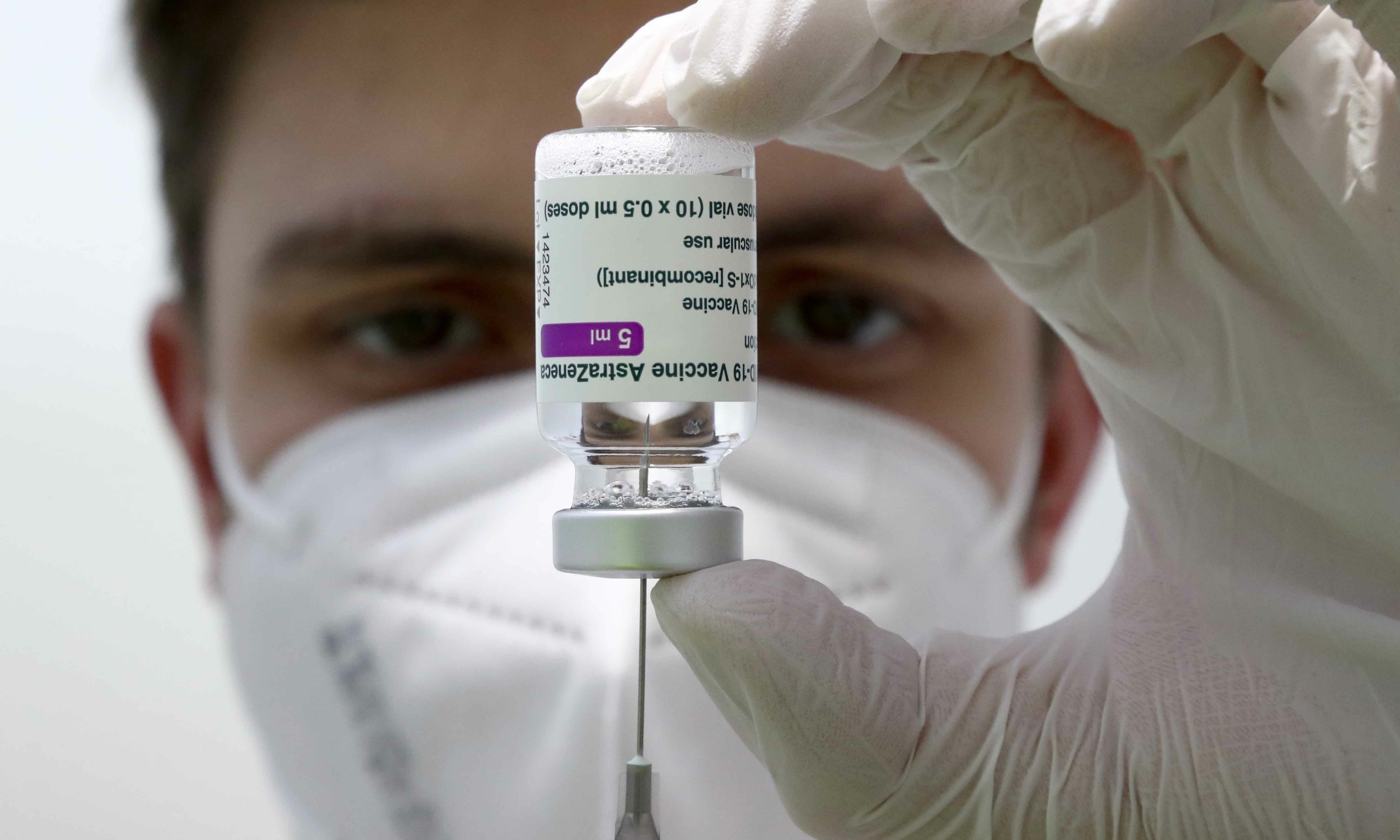 Medical staff prepares a syringe from a vial of the AstraZeneca coronavirus vaccine during preparations at the vaccine center in Ebersberg near Munich on March 22. — AP