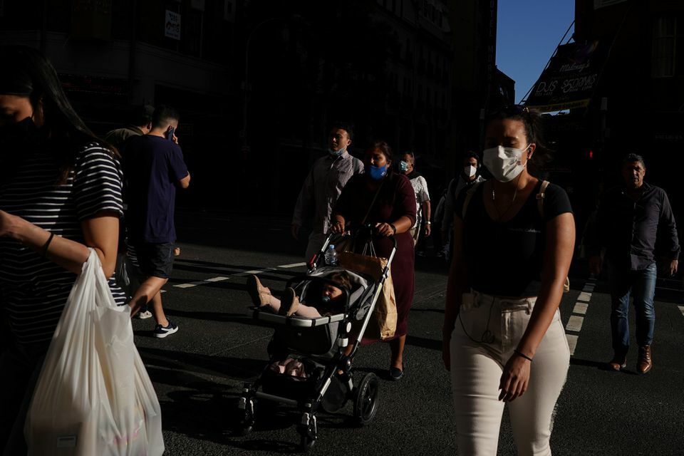 Pedestrians walk through the city centre in the wake of coronavirus regulations easing in Sydney, Australia, October 20. — Reuters