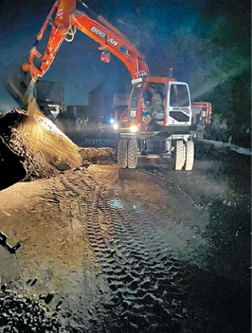 GUJRAT: A trench dug up near the Chenab bridge being filled. &mdash; Dawn