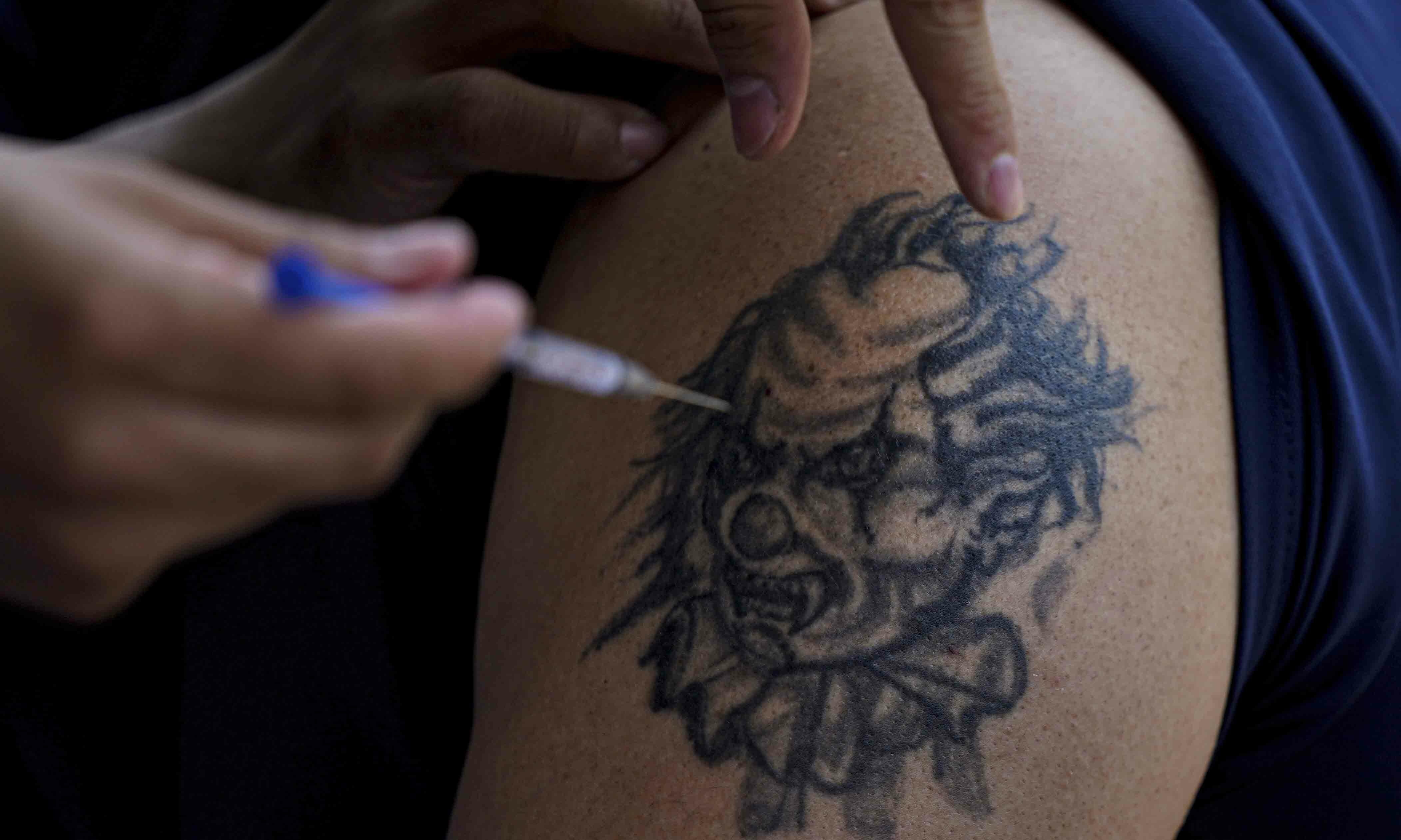 A youth receives a shot of Russia's Sputnik V coronavirus vaccine during a vaccination drive at University Stadium in Mexico City, July 23. — AP