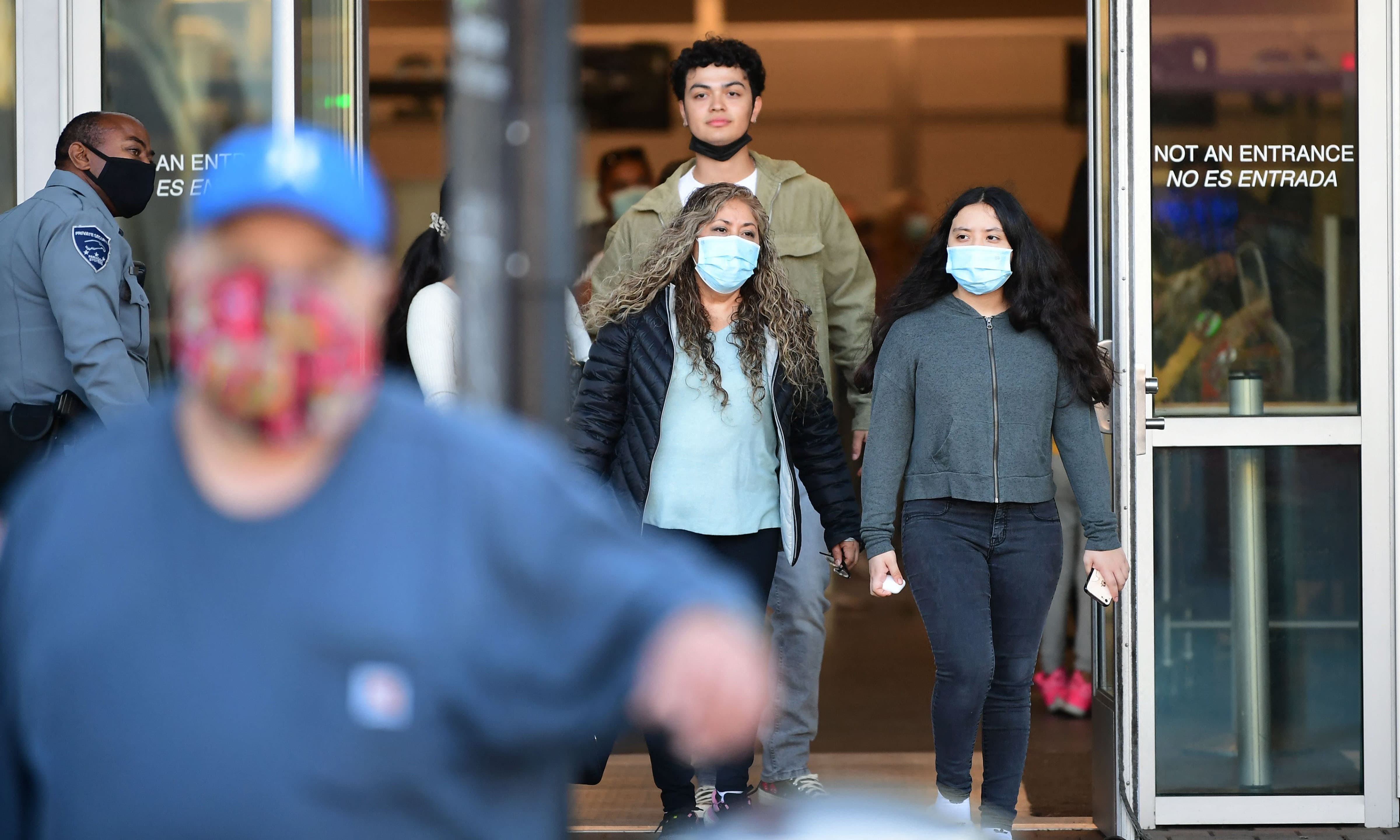 People wear facemasks upon entry into the United States at the San Ysidro Land Port of Entry in San Ysidro, California on Sunday. — AFP