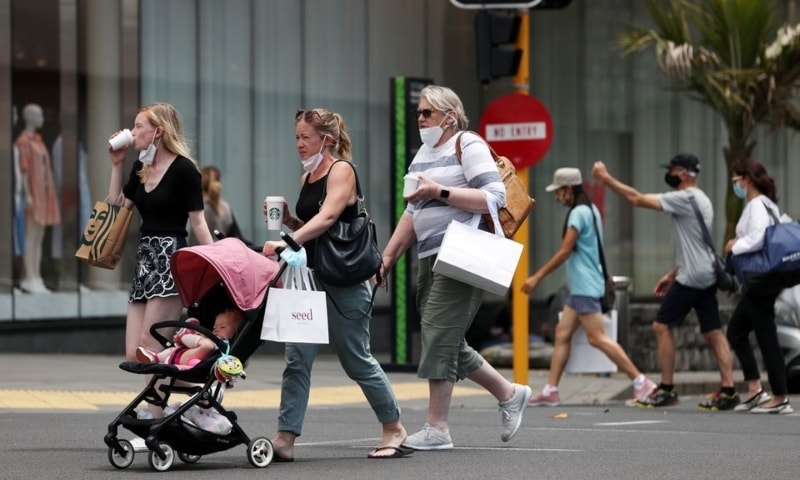 Shoppers walk through a retail district in the wake of coronavirus lockdown restrictions being eased in Auckland, New Zealand, November 10. &mdash; Reuters