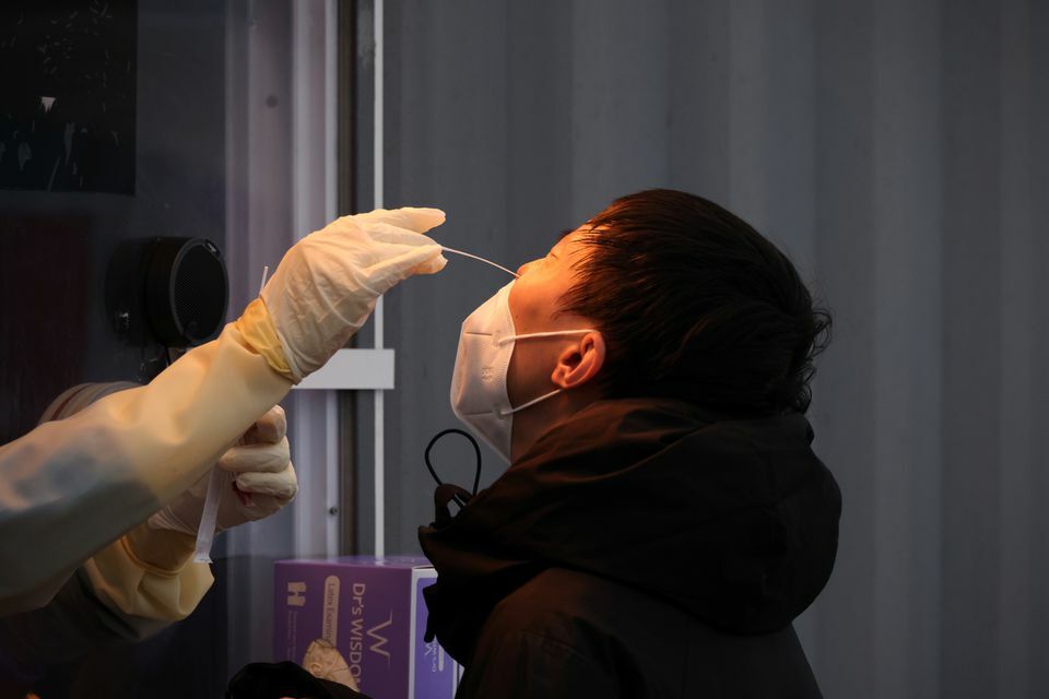 A man undergoes a coronavirus test at a testing site in Seoul, South Korea, November 10. — Reuters