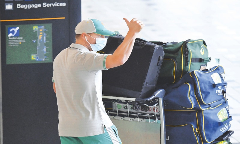 BRISBANE: Australian opener David Warner gives a thumbs up as he arrives with the rest of the squad at the Brisbane International Airport on Tuesday.—AP