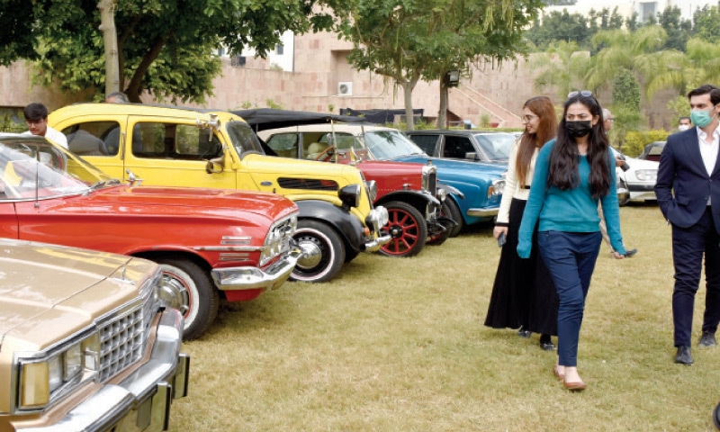 visitors look at vintage vehicles displayed at the ‘Heritage on Wheels’ show in Islamabad on Tuesday. — Photo by Tanveer Shahzad