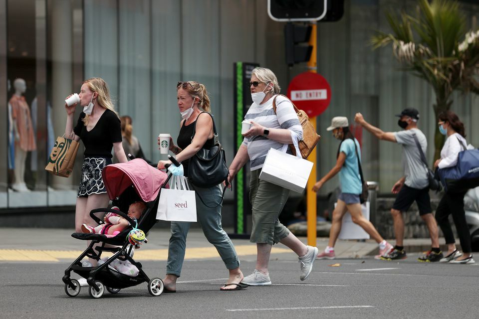 Shoppers walk through a retail district in the wake of coronavirus lockdown restrictions being eased in Auckland, New Zealand, November 10. &mdash; Reuters