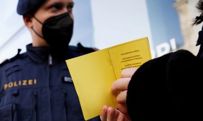 A police officer checks the vaccination status of a shopper at the entrance of a store in Vienna, Austria, November 16. — Reuters