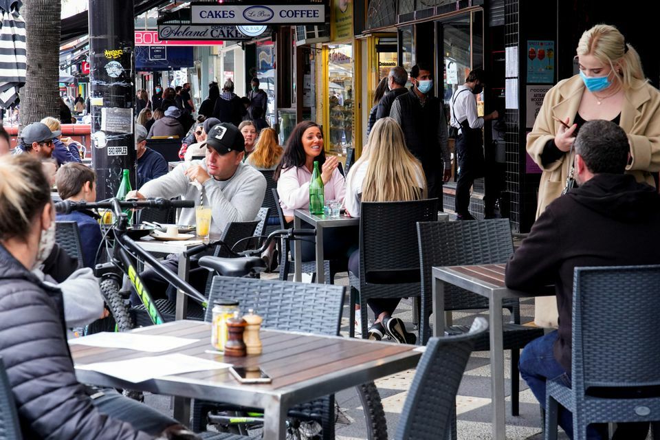 Diners eat outside a restaurant on the second day of eased coronavirus regulations in Melbourne, Australia, October 23. — Reuters