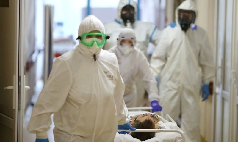 Medical specialists wearing protective gear transport a patient at the City Clinical Hospital Number 1 in Volzhsky, Russia, October 25. — Reuters