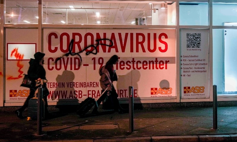 Women walk past an abandoned coronavirus test centre in Frankfurt on Nov 18. — AP
