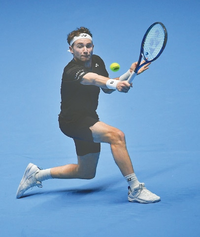 TURIN: Norway’s Casper Ruud hits a return to Cameron Norrie of Britain during their round-robin match of the ATP Finals at the Pala Alpitour.—AFP