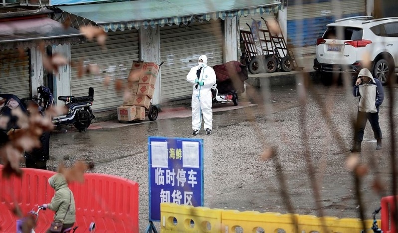 A worker in a protective suit is seen at the closed seafood market in Wuhan, Hubei province, China on January 10, 2020. — Reuters
