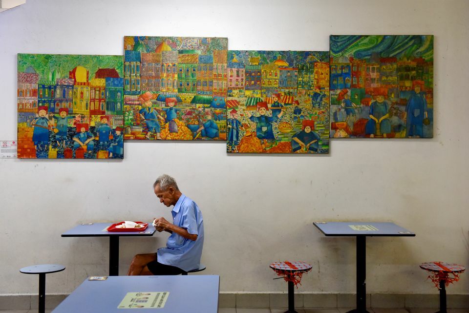 A man dines alone in a food centre, amidst dining regulations imposed by the government which only allow up to two people to dine together, in Singapore, November 3. — Reuters