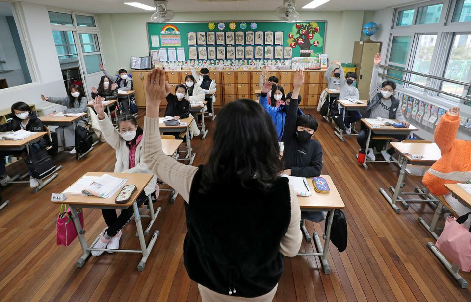 Children attend a class at an elementary school in Daejeon, South Korea, November 22. — Reuters