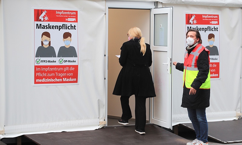 A woman enters a vaccination booth at a coronavirus drive-in vaccination centre at Lanxess Arena in Cologne, Germany. — Reuters