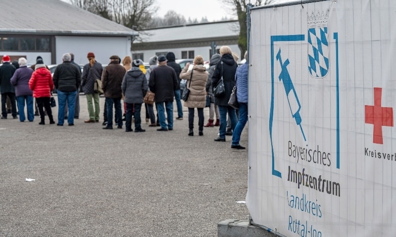 People stand in line in front of a Covid-19 vaccination center in Eggenfelden, Germany on Nov 24. — AP