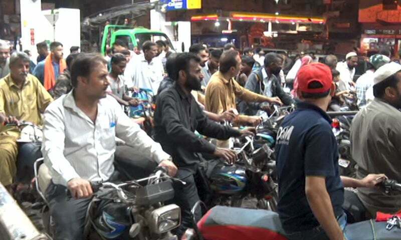 This photo shows motorcyclists waiting outside a petrol station in Karachi. — DawnNewsTV