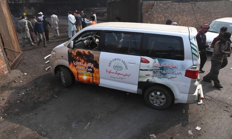 Officials of the environment department Anti-Smog Squad arrive to inspect a steel factory following violation of pollution norms in Lahore. — AFP