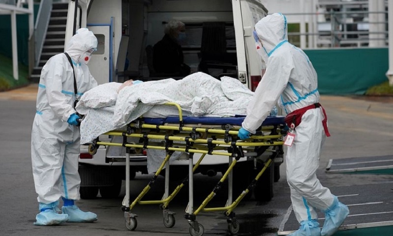 Medical specialists transport a patient outside a hospital for people infected with the coronavirus disease  in Moscow, Russia on Oct 13, 2021.
