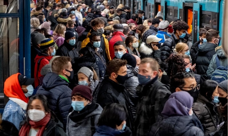 People with face masks stand close together as they wait for a subway train in Frankfurt, Germany on Dec 2, 2020. — AP
