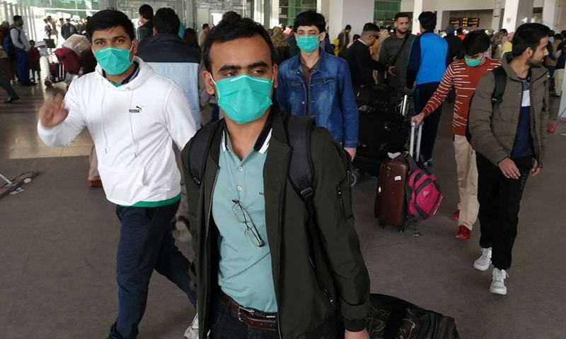 Pakistani students wearing protective facemasks come out upon their arrival from China at the Islamabad International Airport in February 2020. — AFP/File